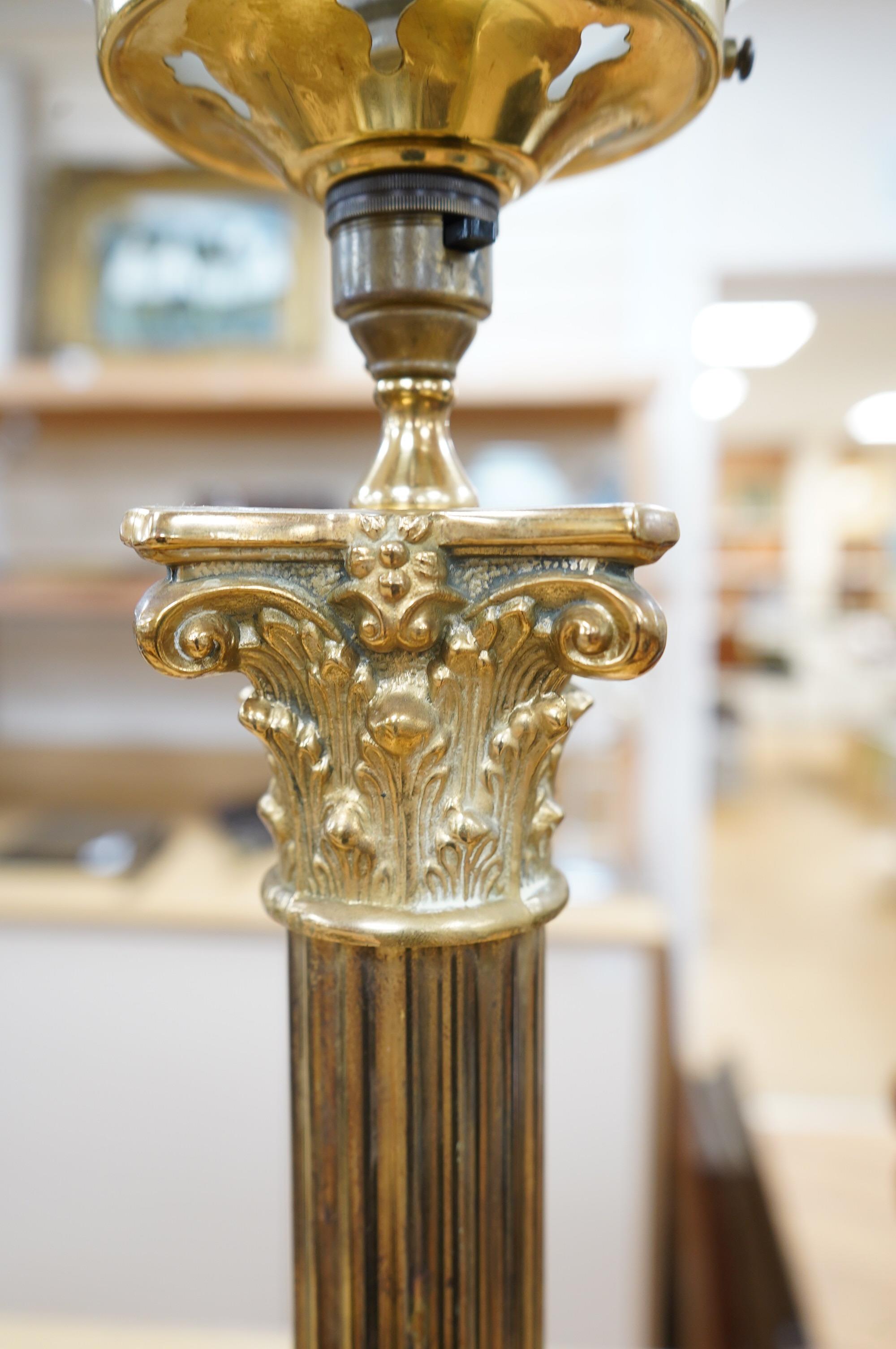 A tall brass Corinthian column table lamp with spherical glass shade, 84cm high including glass shade. Condition - good, brass tarnished at base